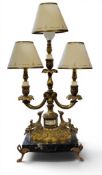 A French style gilt metal three light two branch candelabrum, cast with leafy scrolls and masks,