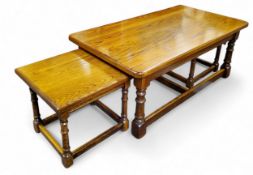 An oak rounded rectangular coffee table, with two smaller tables,  turned legs, block stretchers,