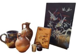 A Chinese black laquered and mother-of-pearl panel, inlaid with fanciful birds and nesting chicks,