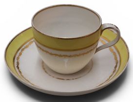 A Pinxton Bute teacup and saucer, pattern no.83, deep yellow band, bordered in gilt, the cup