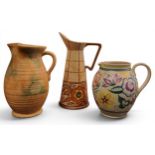 A Bursley Ware Stitch spreading cylindrical jug, designed by Charlotte Rhead, tube lined with
