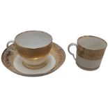 A Pinxton Bute teacup, coffee can and saucer, pattern No.1, banded with gilt seaweed and foliage,