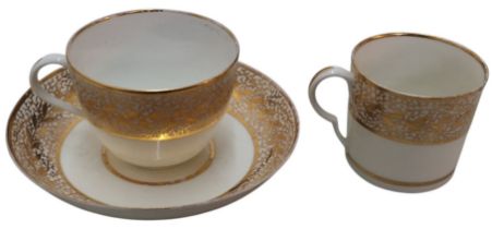 A Pinxton Bute teacup, coffee can and saucer, pattern No.1, banded with gilt seaweed and foliage,