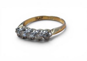 An 18ct gold and diamond ring, claw set with three 6pt round diamonds and two 3pt diamonds, size