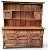 A Fletcher and Mayfield oak dresser, the moulded cornice, the plate rack with fielded panelled