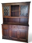 A Jaycee type  furniture oak side cabinet, the top iwith open central shelf, flanked by two astragal