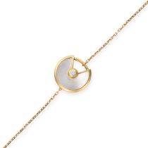 CARTIER, A MOTHER OF PEARL AND DIAMOND AMULETTE DE CARTIER BRACELET in 18ct yellow gold, the