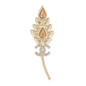 CHANEL, A LEAF BROOCH comprising a gold tone metal brooch in the shape of a leaf, set with two
