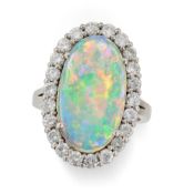 A VINTAGE OPAL AND DIAMOND CLUSTER RING set with an oval cabochon opal of approximately 4.53 carats