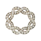AN ANTIQUE DIAMOND BROOCH in yellow gold and silver, the scrolling brooch designed as a wreath, set
