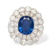 A FINE ANTIQUE SAPPHIRE AND DIAMOND CLUSTER RING, EARLY 20TH CENTURY set with a cushion cut sapphire