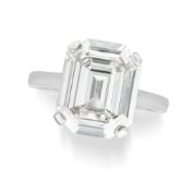 A FINE ART DECO SOLITAIRE DIAMOND RING in platinum, set with a cut cornered rectangular step cut dia