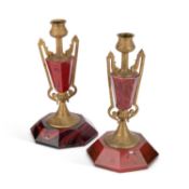 A PAIR OF BRASS AND RED GLASS CANDLESTICKS LATE 19TH/ EARLY 20TH CENTURY