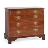 AN OAK CHEST OF DRAWERS