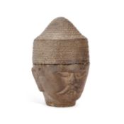 A SOUTH EAST ASIAN CARVED STONE HEAD
