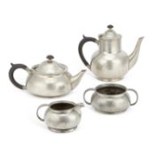 A LIBERTY & CO TUDRIC PEWTER FOUR-PIECE TEA SERVICE THE DESIGN ATTRIBUTED TO ARCHIBALD KNOX (1864-19