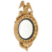 A REGENCY STYLE GILTWOOD CONVEX MIRROR