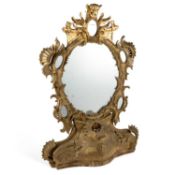 A ROCOCO REVIVAL CARVED AND GILDED MIRROR