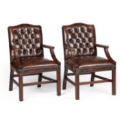 A PAIR OF BROWN LEATHER UPHOLSTERED ARMCHAIRS
