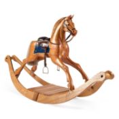 A LARGE CARVED PINE ROCKING HORSE