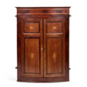 A GEORGE III INLAID OAK AND MAHOGANY HANGING BOW-FRONT CORNER CUPBOARD
