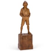 AN EARLY 20TH CENTURY BLACK FOREST CARVED WOOD FIGURE OF A BOY BY A. FICKER