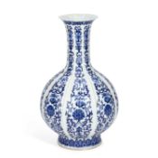 A CHINESE BLUE AND WHITE PORCELAIN VERTICALLY MOULDED AND RIBBED BOTTLE VASE