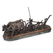 A BRONZE FIGURAL GROUP OF OXEN PLOWING