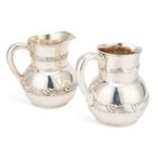 A NEAR PAIR OF AMERICAN SILVER WATER JUGS