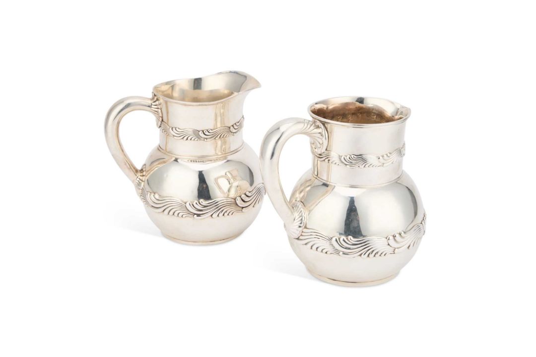 A NEAR PAIR OF AMERICAN SILVER WATER JUGS
