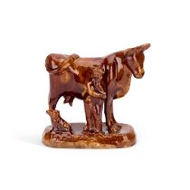 A 19TH CENTURY STAFFORDSHIRE TREACLE-GLAZED COW GROUP