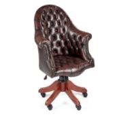 A DEEP-BUTTONED BROWN LEATHER DESK CHAIR