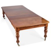 A LARGE VICTORIAN MAHOGANY EXTENDING DINING TABLE