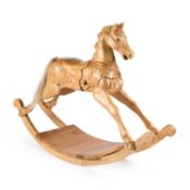 A CARVED PINE ROCKING HORSE 20TH CENTURY