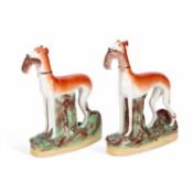 A PAIR OF VICTORIAN STAFFORDSHIRE POTTERY GREYHOUND COURSING FIGURES