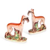 A PAIR OF VICTORIAN STAFFORDSHIRE POTTERY GREYHOUND COURSING FIGURES