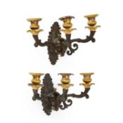 A PAIR OF 19TH CENTURY PARCEL-GILT BRONZE THREE-LIGHT WALL SCONCES IN THE EMPIRE TASTE
