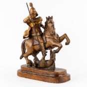 An antique wood-sculptured and patinated 'Saint Michael and The Dragon', Late 19th or Early 20th C.