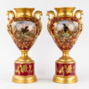 A Pair of Urns or Vases on a Stand, glazed faience, hand-painted and gilded decorations, 19th/20th C
