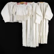 Lithurgical Vestments: Two albs and two altar servers’ robes, finished with lace.