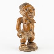 An African fertility figurine, terracotta, Yoruba Ibeji style.