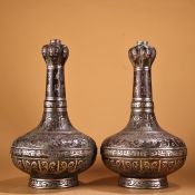 A pair of bronze garlic-shaped vases inlaid with silver