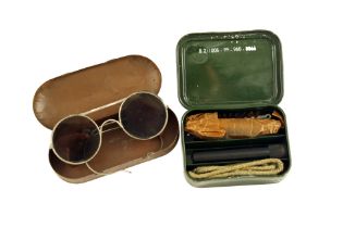 A Pair of Military Issue Sunglasses and Gun Cleaning Kit