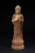 AN EAST ASIAN POLYCHROME DECORATED CARVED WOOD FIGURE OF A STANDING BUDDHA.