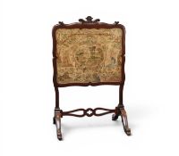 A Victorian mahogany fire screen with 17th century needlework panel