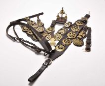 A collection of horse brasses and a horse bell