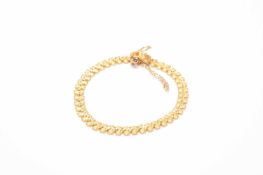 A yellow metal bracelet