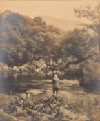 A late 19th century albumen print of a fly fisherman by a riverside