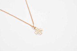 A yellow metal cross pendant on chain