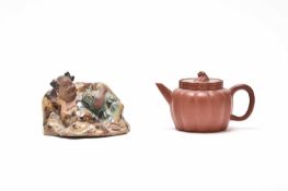 A Chinese Yixing melon teapot and a Chinese Shiwan model of Liu Hai, late 19th/20th century
